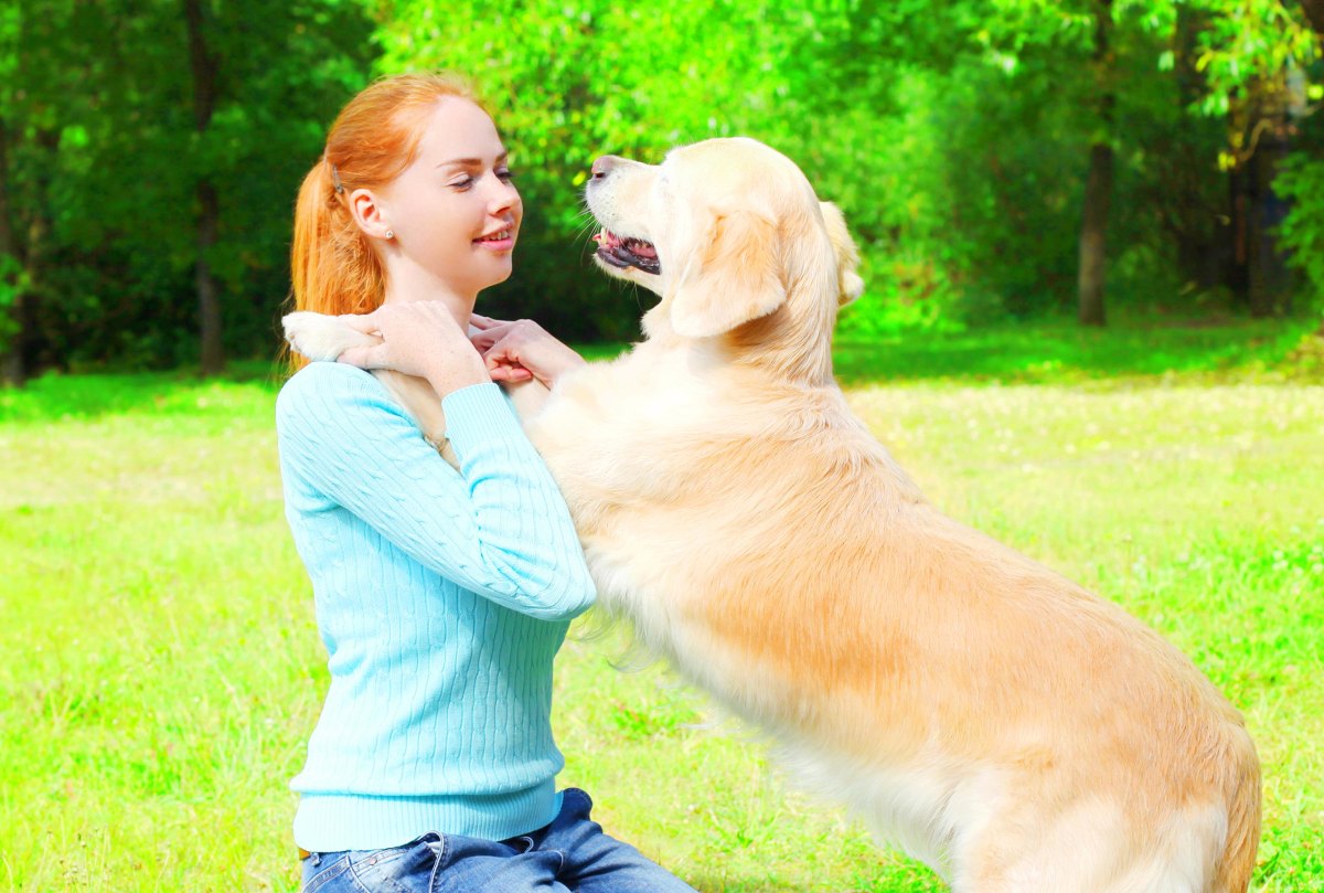 Dog placing paws on owner's shoulders