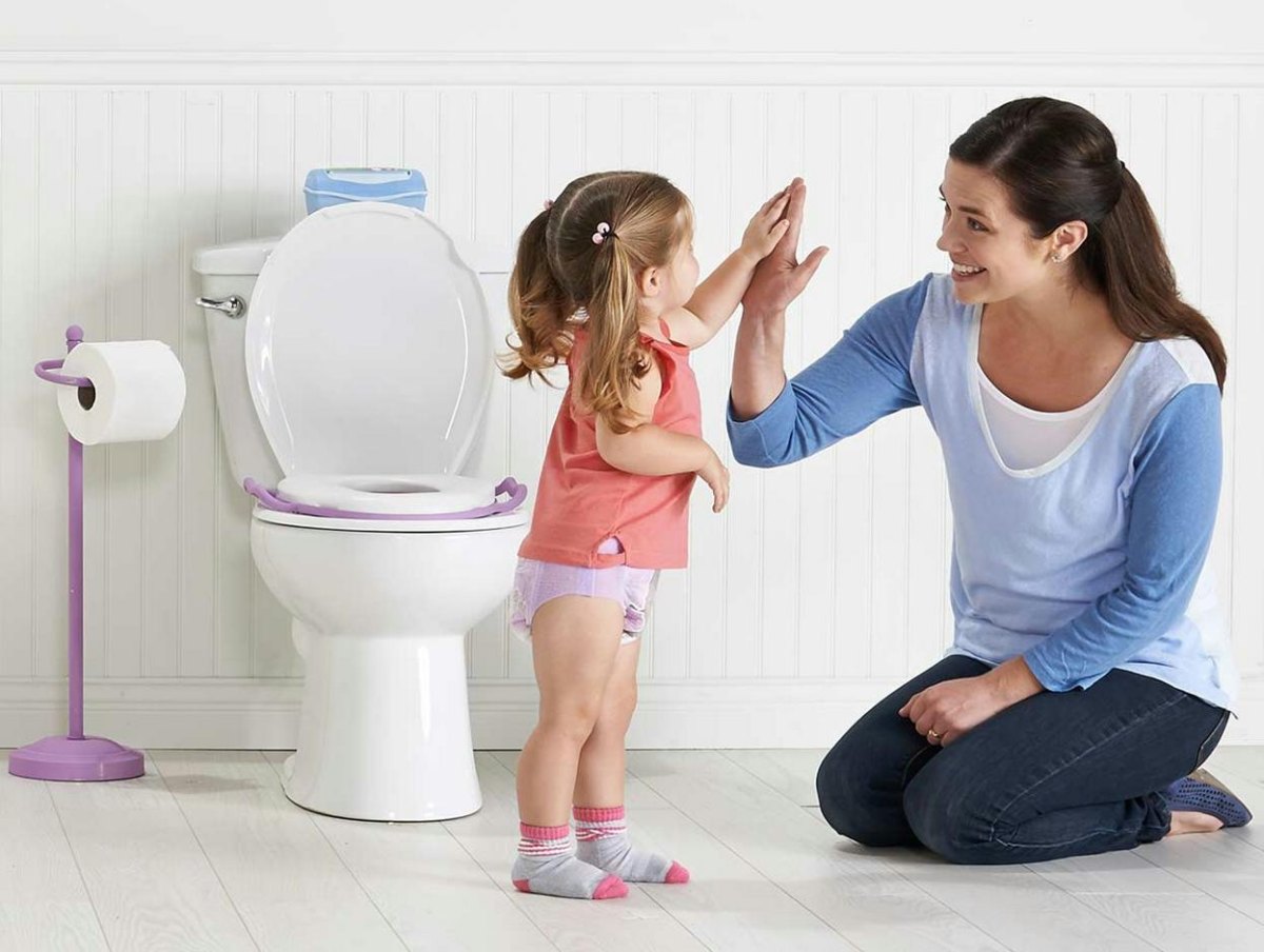 Toddler receiving praise after potty success